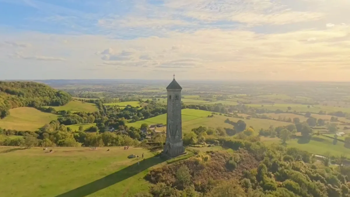 The Tyndale Monument from the air in evening light, its shadow across the grass and the Severn Vale beyond